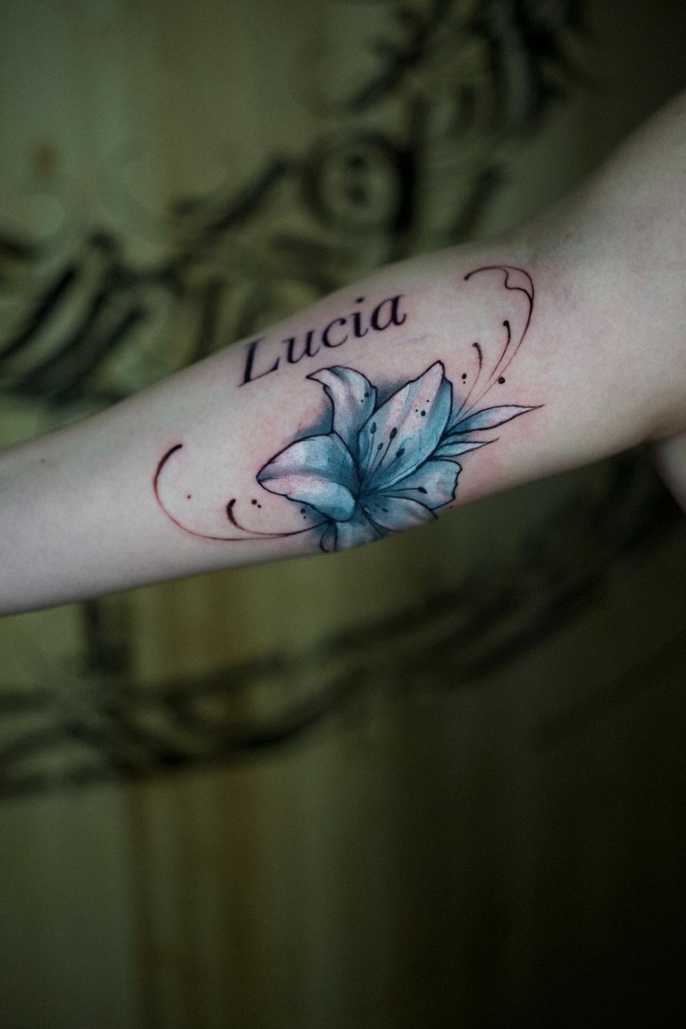 script name lettering with floral upper arm tattoo by Antwan Rodriguez, West Palm Beach FL
